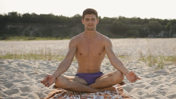 Sports Guy Meditates On The Beach