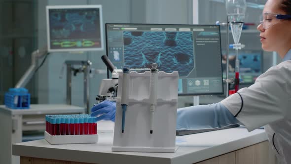 Scientist Woman Sitting in Laboratory with Chemical Technology