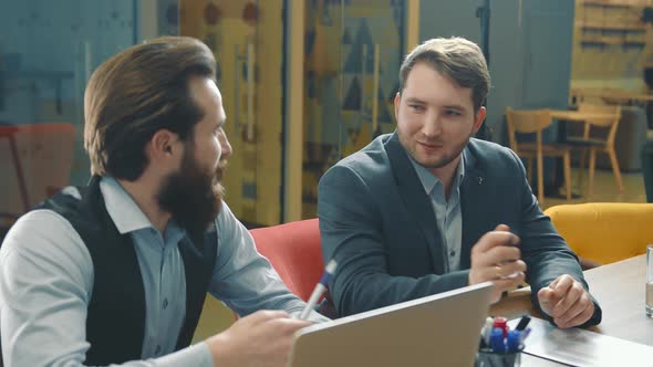 Two Men Are Business Partners Have a Dialogue and Communicate in the Office