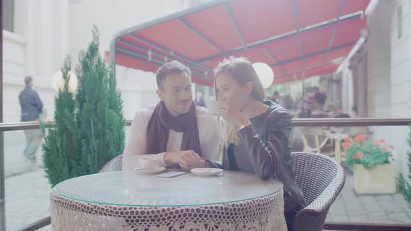 Couple In Love Drinking Coffee On Romantic Date In Cafe Outdoors