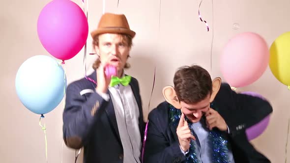 Two male friends dancing in photo booth