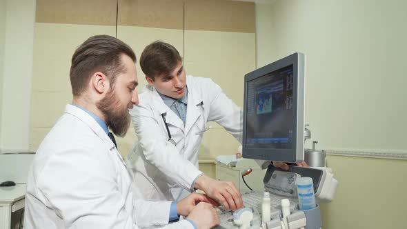 Two Doctors Discussing Ultrasound Scanning Results of a Patient