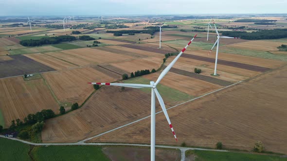 Windmill Turbine in the Field at Summer Day