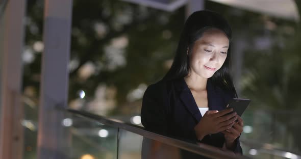 Businesswoman use cellphone at night