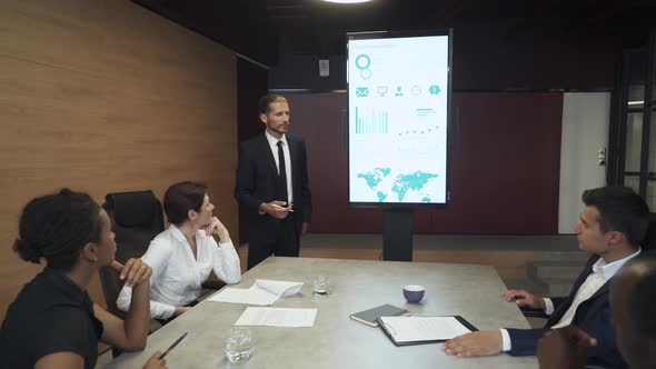 Business Meeting in Office, Young Businessman Speak at a Meeting and Shows Financial Infographic in