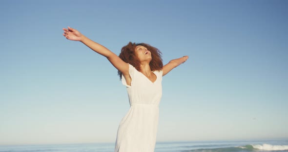 African American woman enjoying the fresh air of the beach