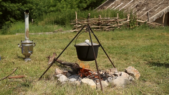 The Cauldron on a Tripod Heated on a Campfire