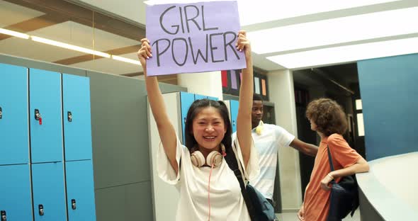Asian Girl Teenager at School Holding a Poster with the Slogan Girl Power