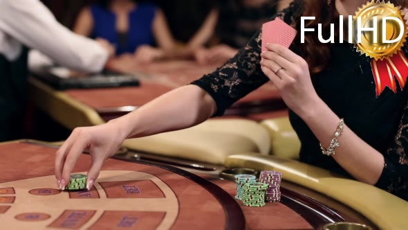 Woman Takes the Card and Makes a Bet in a Casino