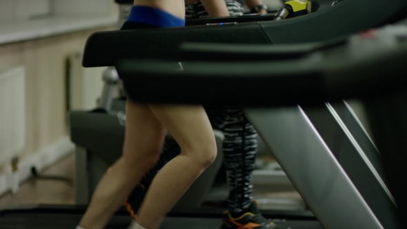 Pretty Smiling Blond Woman Running On Treadmill