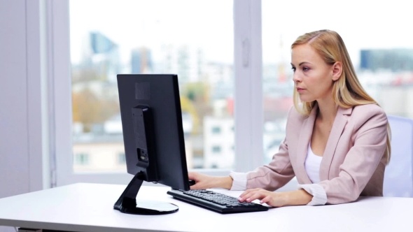 Young Businesswoman With Computer Typing At Office 9