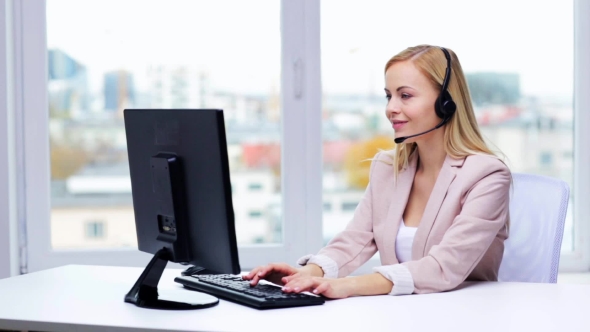 Businesswoman With Computer And Headset Talking 24