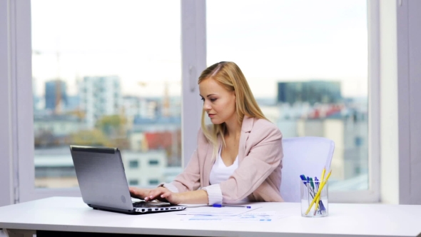 Smiling Businesswoman With Laptop And Papers 47