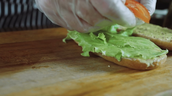 Chef Cuts Puts Tomatoes On The Sandwich