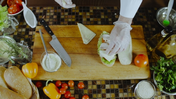 Chef Adds Cheese To The Sandwich