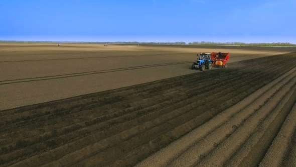 Planting Potatoes With Tractor.The Planter On The Field.The Introduction Of Fungicides.Aerial View