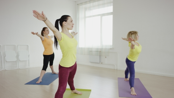 Slender Fit Women Doing Yoga On Exercise 