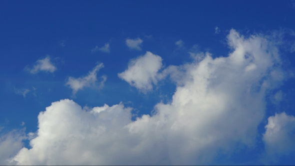 Clouds Rolling Through Bright Blue Sky