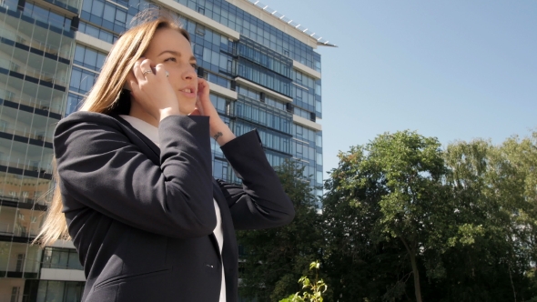 Portrait Of Business Woman Making a Phone Call Outside Business Center