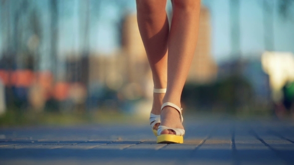 Young Women Feet Walking On Street.