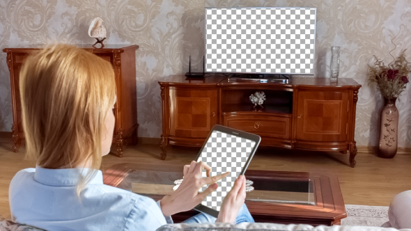 Girl Using Tablet In Front Of The TV 1 With Isolated Screen 