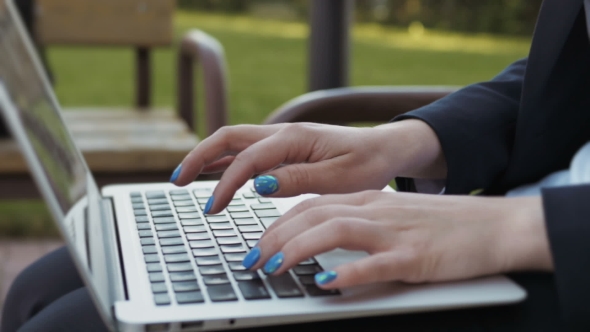 Female Hands On Laptop Keyboard - Woman Typing On Notebook Outdoors 