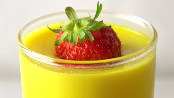 Rotating Yellow Pannacotta Dessert With Strawberry   Video