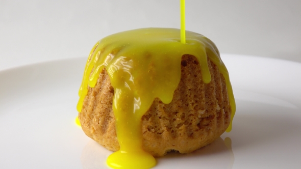 Covering Freshly Baked Muffin With Yellow Sauce  Video