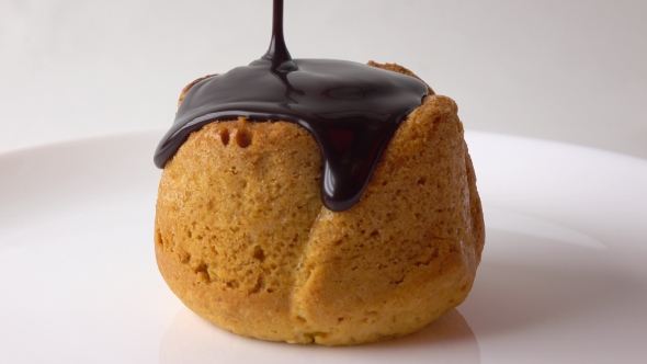 Covering Freshly Baked Muffin With Dense Chocolate Sauce  Video