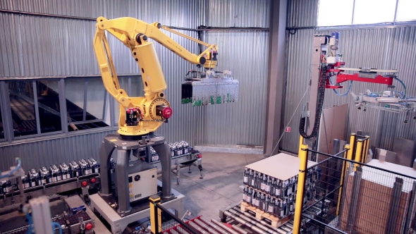 Automated Robotic Arm Loading And Assembling Products.