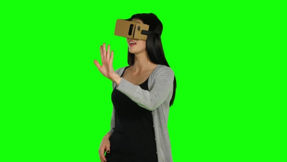Girl In Virtual Reality Is Smilling And It Makes Him Laughing. Green Screen