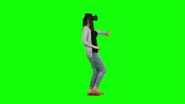 Woman In a Virtual Reality Mask Walking. Green Screen