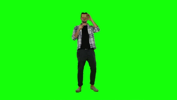 Man Looking Into a Virtual Reality Glasses. Green Screen