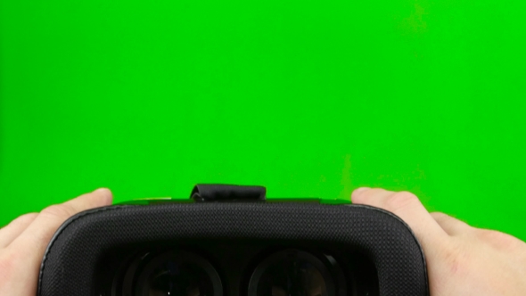 Male Hand Taking a Virtual Reality Headset. Virtual Reality Mask. Green Screen. 