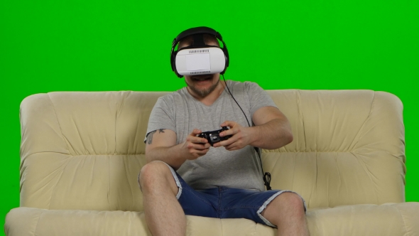 Man In Virtual Reality Glasses. Green Screen