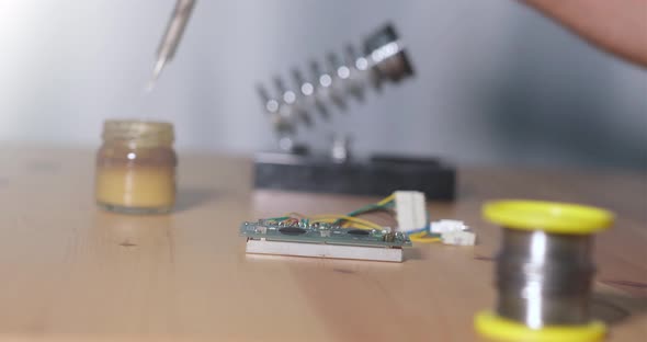 Male Technician Soldering Electronic Circuit Board.