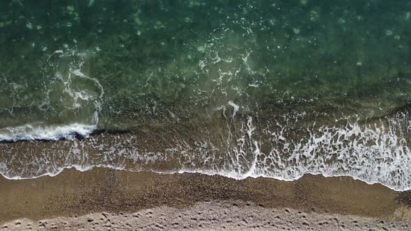 Aerial View From Above on Calm Azure Sea and Volcanic Rocky Shores