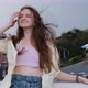 Young Woman with Long Hair Stands on Balcony on City Background - VideoHive Item for Sale