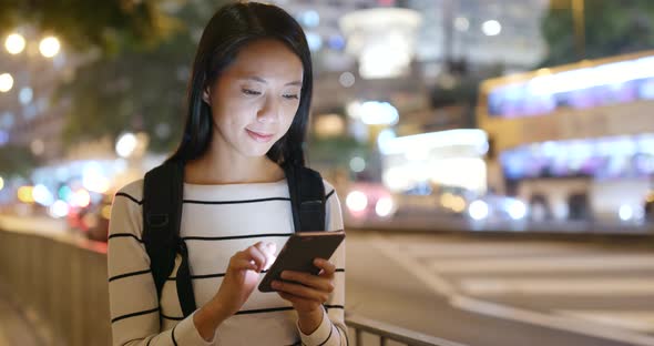 Woman use of smart phone in city 