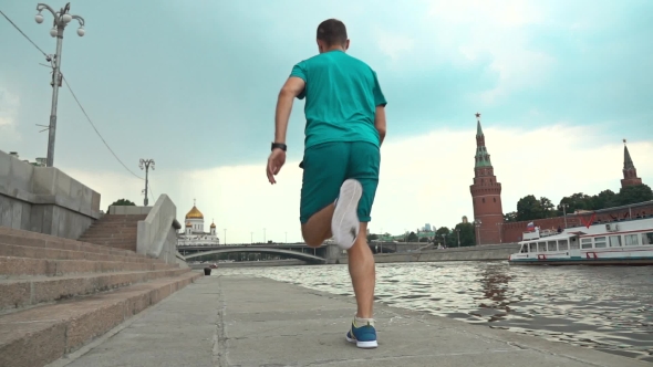 Athletic Male Running Against Moscow Kremlin. Super  Steadicam Video 240 Fps