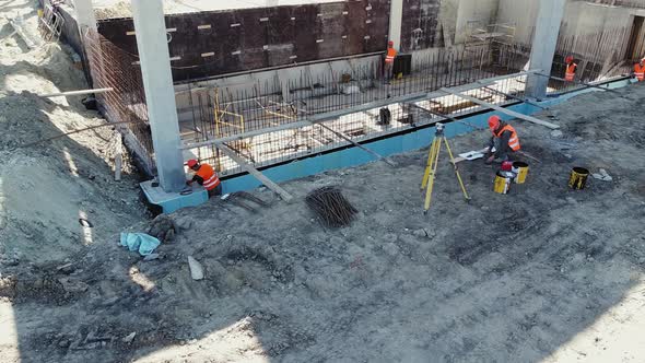 Construction Site Manager Looks at the Floor Plans