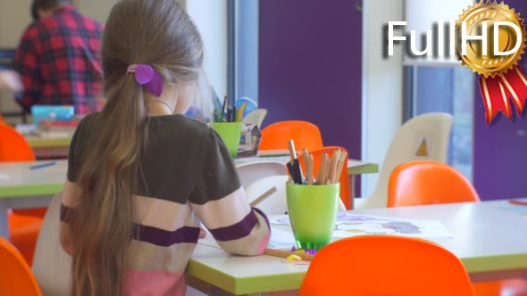 Educator's Hand Takes a Pencil From a Cup Kid