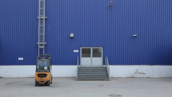 Loader Sits In Electric Forklift And Drive It