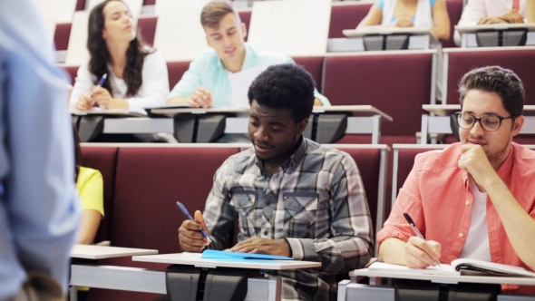 Group Of Students With Notebooks In Lecture Hall