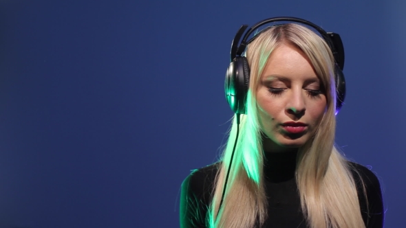 Young Woman Listening Music Through Headphone 