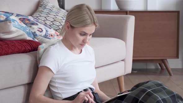 Portrait in profile attractive blonde businesswoman relaxing near sofa 