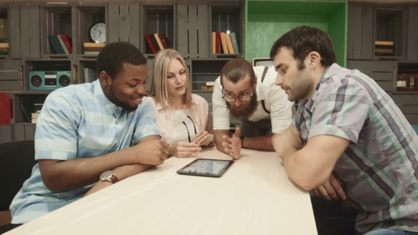 Mix-raced Group Of Businesspeople Using Tablet