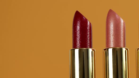 A slider of movement of lipsticks of different colors. Cosmetics for women