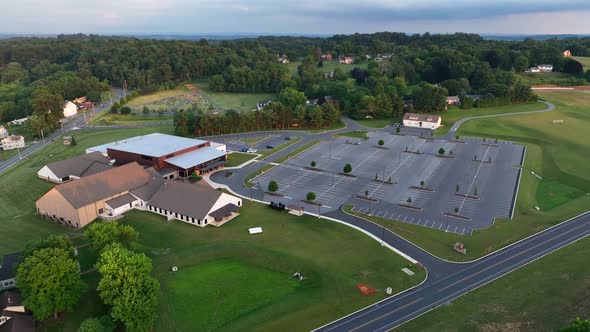 Aerial footage of church. Megachurch with huge building and big parking lot. Religion theme.