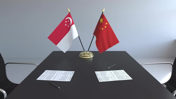 Flags of Singapore and China on the Table